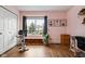 A bedroom with pink walls, natural light, desk, decor, and exercise equipment at 1032 Grovewood Dr # 0, Beech Grove, IN 46107