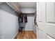 A well-organized walk-in closet with metal shelving, wooden accents, and a stool at 1032 Grovewood Dr # 0, Beech Grove, IN 46107