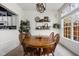 Bright dining room featuring a wooden table, stylish decor, and natural light from a window at 1032 Grovewood Dr # 0, Beech Grove, IN 46107
