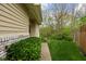 Green lawn with lush bushes and sidewalk leading to entrance of a townhome at 1032 Grovewood Dr # 0, Beech Grove, IN 46107