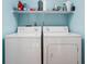 A laundry room with a white washer and dryer and wire rack shelving at 1032 Grovewood Dr # 0, Beech Grove, IN 46107