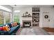 Cozy living room featuring a fireplace, built-in shelving, and comfortable seating with natural light at 1032 Grovewood Dr # 0, Beech Grove, IN 46107