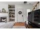 Inviting living room with a fireplace, built-in shelves, and a view of the front door and staircase at 1032 Grovewood Dr # 0, Beech Grove, IN 46107