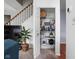 Organized pantry with wire shelving, providing ample storage space near the stairs and living area at 1032 Grovewood Dr # 0, Beech Grove, IN 46107