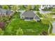 Aerial view highlights the property's large, manicured lawn, screened patio, and mature trees at 10794 Pine Needle Ct, Fishers, IN 46037