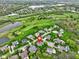 Scenic aerial view of houses nestled on a lush golf course with beautiful ponds and mature trees at 10794 Pine Needle Ct, Fishers, IN 46037