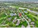 Aerial view of a residential neighborhood with ponds, a golf course, and tree-lined streets at 10794 Pine Needle Ct, Fishers, IN 46037