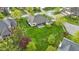 Aerial view showcases a well-maintained backyard with lush greenery, mature trees, and privacy fencing at 10794 Pine Needle Ct, Fishers, IN 46037