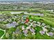 Aerial view of a lush residential neighborhood with mature trees, a golf course, and tranquil ponds at 10794 Pine Needle Ct, Fishers, IN 46037
