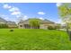 View of fenced backyard with lush lawn, fire pit and view of the screened in patio, great for entertaining at 10794 Pine Needle Ct, Fishers, IN 46037
