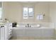 This bathroom has tile flooring, a garden tub, and neutral walls at 10794 Pine Needle Ct, Fishers, IN 46037