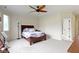 This bedroom has carpet flooring, a large window, and neutral walls at 10794 Pine Needle Ct, Fishers, IN 46037