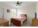 This bedroom has carpet flooring, a ceiling fan, and two dressers at 10794 Pine Needle Ct, Fishers, IN 46037