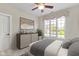 This bedroom has carpet flooring, a dresser, and a large window at 10794 Pine Needle Ct, Fishers, IN 46037