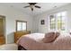 Comfortable bedroom with a ceiling fan, window, and dresser at 10794 Pine Needle Ct, Fishers, IN 46037