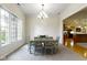 Bright dining room featuring a modern chandelier, a large window, and a table with six chairs at 10794 Pine Needle Ct, Fishers, IN 46037