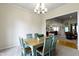 Dining room with a modern chandelier and an adjacent view into the kitchen and living areas at 10794 Pine Needle Ct, Fishers, IN 46037