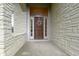 Close up of front door with stone surround and transom window at 10794 Pine Needle Ct, Fishers, IN 46037