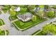 Aerial view of a home with lush lawn, professional landscaping, and a nearby pond at 10794 Pine Needle Ct, Fishers, IN 46037