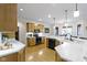 Bright kitchen with white countertops, wood cabinets, and a view to the dining area at 10794 Pine Needle Ct, Fishers, IN 46037