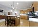 Open-concept kitchen features a spacious island, hardwood floors, and stainless steel appliances at 10794 Pine Needle Ct, Fishers, IN 46037