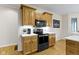 Efficient kitchen with black microwave and oven, featuring light countertops and wood cabinets at 10794 Pine Needle Ct, Fishers, IN 46037