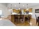 Charming kitchen island with seating, complemented by wooden cabinets and modern lighting fixtures at 10794 Pine Needle Ct, Fishers, IN 46037