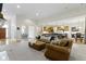 Spacious living room with an open floor plan featuring a leather sofa set and a view to kitchen and dining areas at 10794 Pine Needle Ct, Fishers, IN 46037