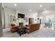 Comfortable living room with built-in shelving, a fireplace, and an open view into the dining room at 10794 Pine Needle Ct, Fishers, IN 46037