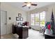 This office has carpet flooring, a ceiling fan, and a large window at 10794 Pine Needle Ct, Fishers, IN 46037