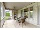 Screened in patio with seating area, outdoor lighting, and view of backyard and white brick at 10794 Pine Needle Ct, Fishers, IN 46037
