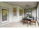 Covered patio features stone walls, a ceiling fan, and an outdoor dining area, perfect for relaxing and entertaining at 10794 Pine Needle Ct, Fishers, IN 46037
