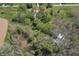 Aerial view of wooded property with water feature with some flooding; includes hints of a distant house and neighborhood at 10912 N County Road 950 E, Brownsburg, IN 46112