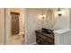 Bathroom features an elongated vanity, decorative mirror and a glass enclosed shower with tiled flooring at 10912 N County Road 950 E, Brownsburg, IN 46112