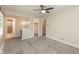 Spacious bedroom with ceiling fan features an ensuite bathroom, neutral paint, plush carpet and ample closet space at 10912 N County Road 950 E, Brownsburg, IN 46112