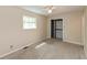 Carpeted bedroom featuring a closet with wire shelving and natural light from a window at 10912 N County Road 950 E, Brownsburg, IN 46112