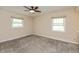 Bright bedroom boasts neutral paint, plush carpet and large windows to provide generous natural lighting at 10912 N County Road 950 E, Brownsburg, IN 46112