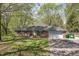 Charming brick home with an attached garage, lush lawn, and classic curb appeal in a serene, wooded setting at 10912 N County Road 950 E, Brownsburg, IN 46112