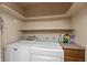 Practical laundry area with modern washer and dryer, along with open shelving at 10912 N County Road 950 E, Brownsburg, IN 46112