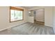 Inviting room featuring neutral walls, large window with a view, and plush carpet at 10912 N County Road 950 E, Brownsburg, IN 46112