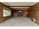 Cozy living room featuring a brick fireplace and wood-paneled walls, creating a rustic charm at 10912 N County Road 950 E, Brownsburg, IN 46112