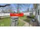 Side view of house with trash can and dumpster in the backyard at 1114 N Mount St, Indianapolis, IN 46222