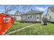 Back view of house with grass and a dumpster in the background at 1114 N Mount St, Indianapolis, IN 46222
