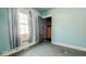 Bedroom featuring pale blue walls, a large window, and doorway with an open closet at 1114 N Mount St, Indianapolis, IN 46222