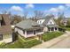 Attractive home with a screened porch, set on a well-manicured lot with green grass and mature trees at 1114 N Mount St, Indianapolis, IN 46222