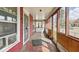 View of the home's bright, enclosed porch with space for seating and enjoying the outdoors at 1114 N Mount St, Indianapolis, IN 46222