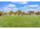 Large, grassy backyard with storage sheds and mature trees, perfect for outdoor activities at 120 Crosby Dr, Indianapolis, IN 46227