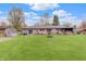 Lush backyard featuring a well-maintained lawn, patio area, and mature trees at 120 Crosby Dr, Indianapolis, IN 46227