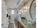 Bright bathroom featuring dual glass bowl sinks, granite countertops, and decorative pendant lighting at 120 Crosby Dr, Indianapolis, IN 46227