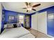 Comfortable bedroom featuring hardwood floors, ceiling fan, and bright blue walls at 120 Crosby Dr, Indianapolis, IN 46227